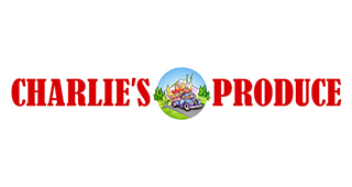 Charlie's Produce logo with “CHARLIE'S” on the left and “PRODUCE” on the right in bold red letters. In the center, there is a circular illustration of a truck filled with various fresh produce driving through a green landscape.