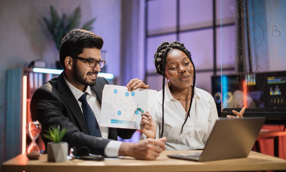 Two workers doing I.T. budget planning.