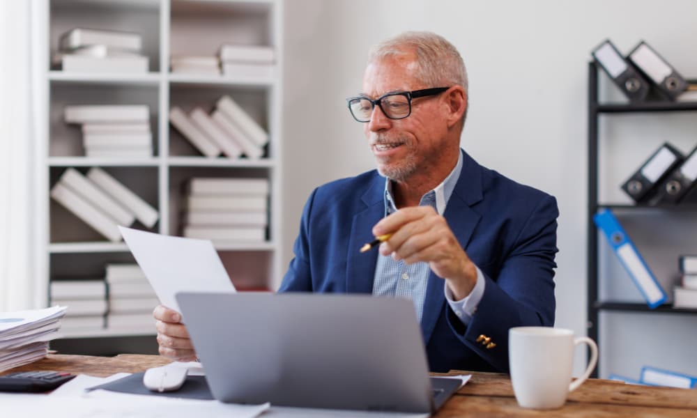 SMB owner reviewing his company’s written data protection program to avoid common FTC compliance pitfalls and ensure financial security.