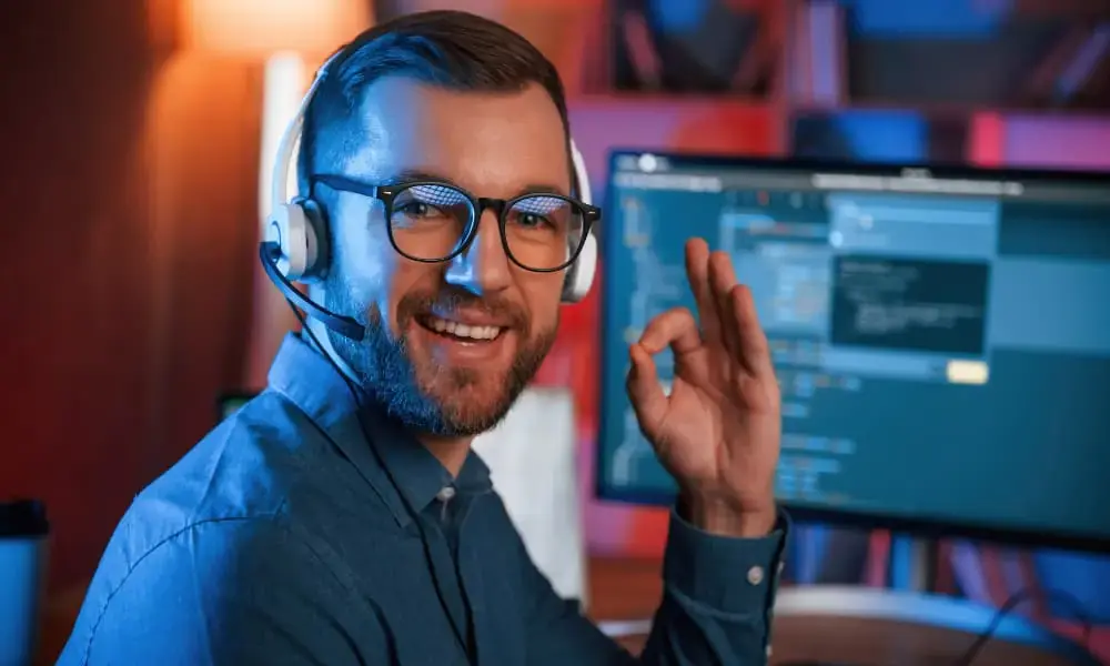 A smiling customer support specialist working in the office