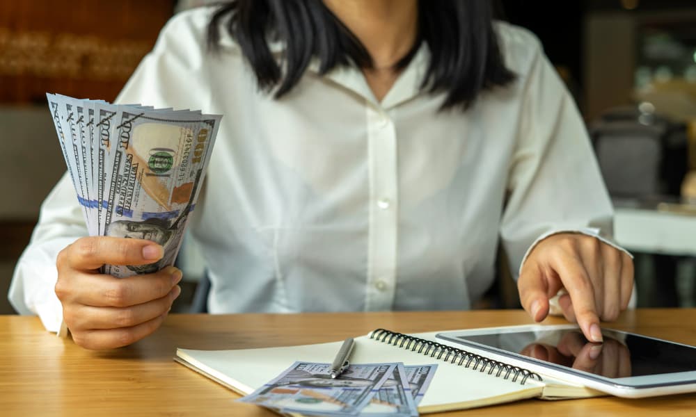 SMB owner calculating inhouse and managed I.T. services costs as part of an MSP contract audit to determine whether they have duplicate I.T. services.