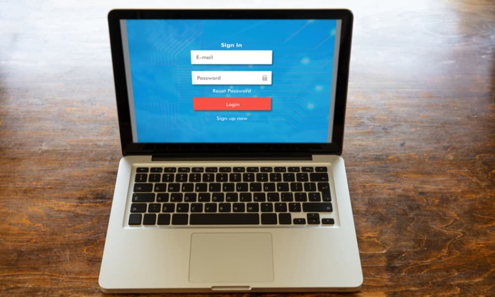 Laptop showing a login screen with email and password fields, illustrating multi-factor authentication for secure business access.