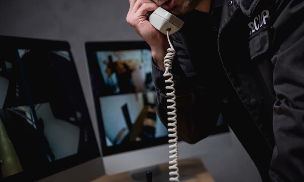 Professional talking on the telephone, consulting VoIP security measures. Professional talking on the telephone, consulting VoIP security measures.